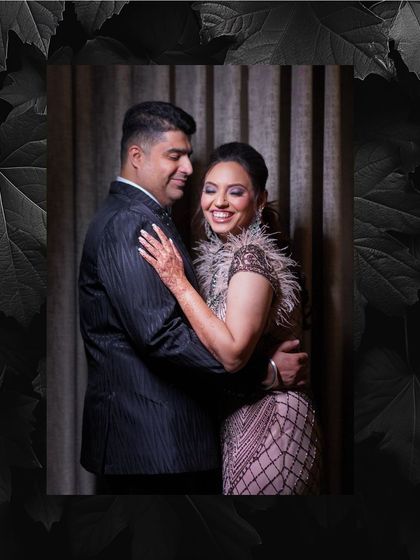 A romantic portrait of the couple at their reception, framed with a dark, leafy border to add a touch of drama.
