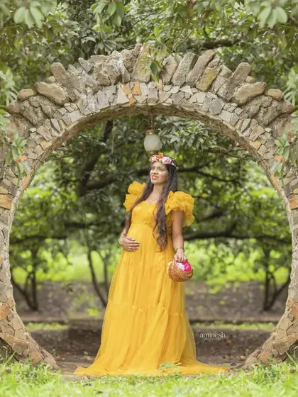 Taking your maternity session outdoors adds a beautiful, natural element. I found this stunning stone archway for a shoot, using the golden hour light to complement this vibrant yellow gown.