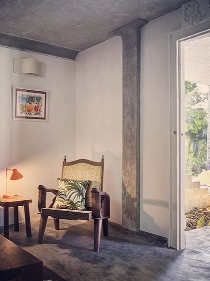 The lobby of the Garden Room, furnished with a mix of antique and contemporary pieces that create a comfortable and eclectic atmosphere.