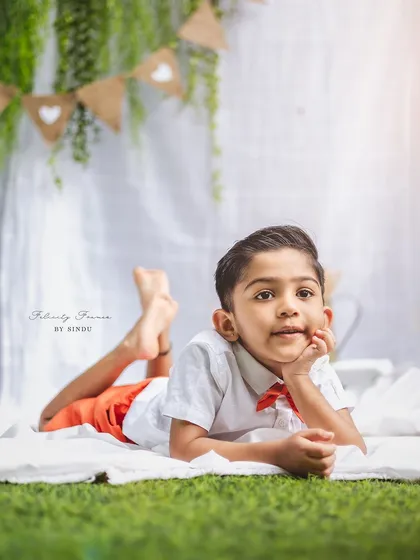 A thoughtful-looking four-year-old boy in an outdoor setting. The simplicity of the shot highlights his natural charm.