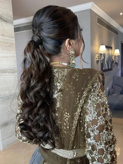 The back of the messy ponytail, showing the texture and curls.