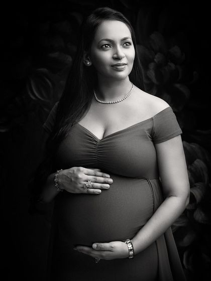A glamorous black and white portrait that exudes elegance. The off-shoulder gown, diamond necklace, and expert lighting create a look of classic Hollywood sophistication.
