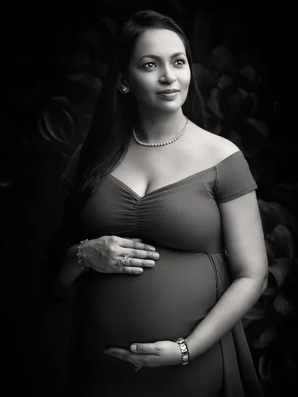 A glamorous black and white portrait that exudes elegance. The off-shoulder gown, diamond necklace, and expert lighting create a look of classic Hollywood sophistication.