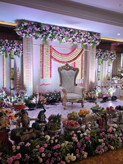 A slightly different angle of the pink and white floral stage, showing the depth of the floral arrangements and the detailed offering table.