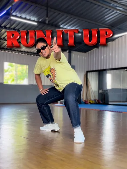 The "Run It Up" challenge is on. This pose captures the playful and confident energy of our street dance classes, where students learn to express themselves fully.