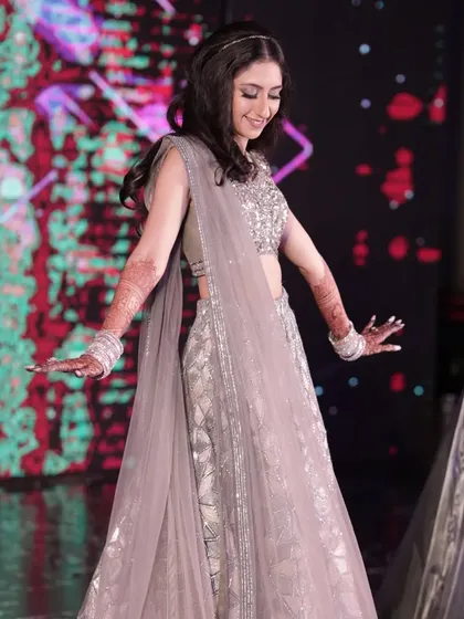 The joy of movement on the sangeet stage. Her makeup was designed to be completely smudge proof and waterproof, allowing her to dance freely without any worries.