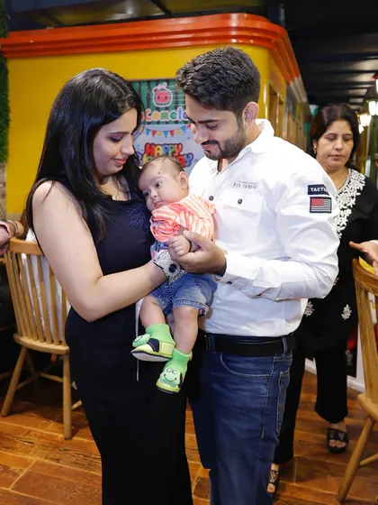 A candid shot of new parents admiring their baby. My venue provides a warm and comfortable atmosphere for families.