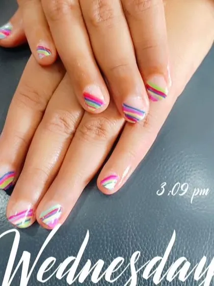 A fun and cheerful design with colorful, thin horizontal stripes on a natural nail base. This shows my precision work and is perfect for anyone who wants a playful yet neat look on shorter, natural nails.