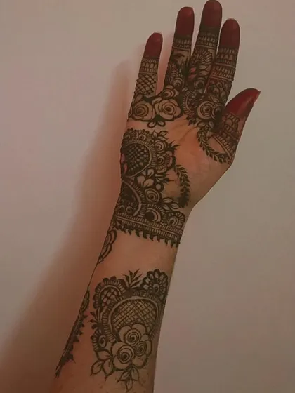 The back of the arm for the previous design, showing how the spaced-out floral motifs continue, creating a cohesive and elegant look.