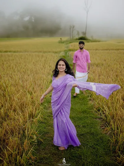 A lovely "follow me" shot through a path in the field. The flowing saree and misty background create a cinematic feel.
