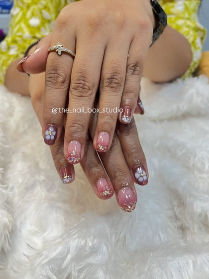 Another view of the 3D floral art on natural nails. The small, sculpted flowers add a beautiful, tactile element to the manicure, making it truly special.