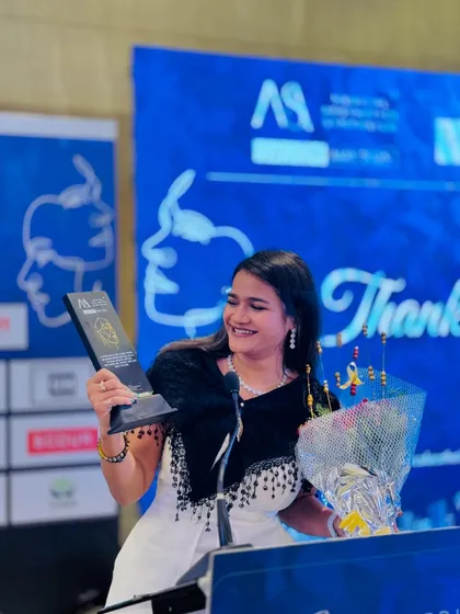 Feeling grateful after being felicitated at the symposium. It's wonderful to be recognized for my contribution to the event's success.