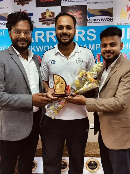 Receiving a token of appreciation at the Warriors Cup. We are committed to promoting the sport of Taekwondo.