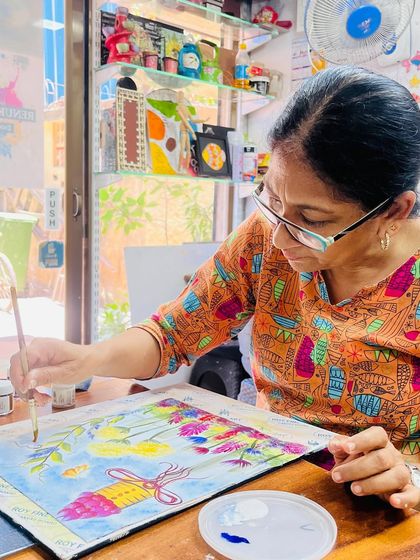 Our workshops are a perfect escape for adults looking to unwind and try something new. This participant is enjoying a relaxing session of fabric painting in our studio.
