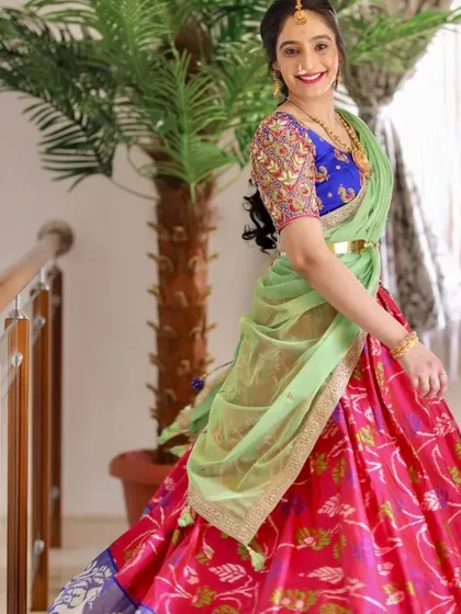 Seeing my creations come to life is the best part of my job. Here, a happy client wears a custom royal blue blouse with a pink and green half-saree for a special occasion, showing how the right blouse can complete a traditional ensemble.
