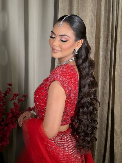 A beautiful shot of my engagement bride Komal. The soft pink eye makeup and long, wavy ponytail create a romantic and modern look.
