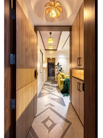 A view from the front door into the home, showcasing the warm lighting and patterned floor that creates an inviting first impression.
