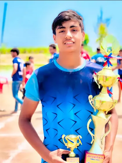 One of our ten players selected for the Under-18 National Championship, proudly holding his trophies. We build champions from a young age.