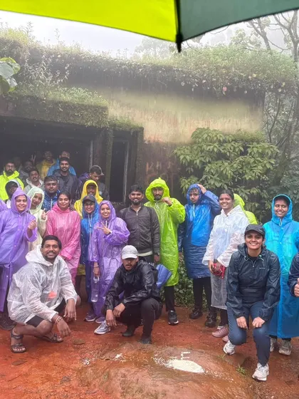 Rain or shine, the trek goes on. A colorful group in their raincoats, ready to embrace the monsoon weather on their way to the peak.