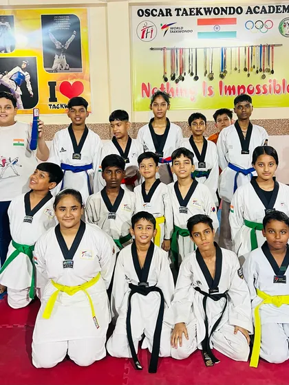 Our students, a mix of different belt levels, posing together. From white to black belt, everyone is part of the same family.