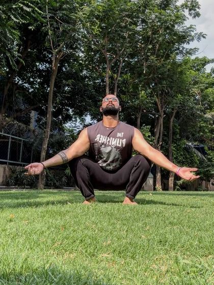 Sometimes the most important work is done outside, in the sun. A deep squat stretch is not just for the hips; it's a moment of mindfulness and meditation.