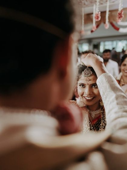 An over-the-shoulder shot capturing the bride's beautiful expression as she looks at her groom.