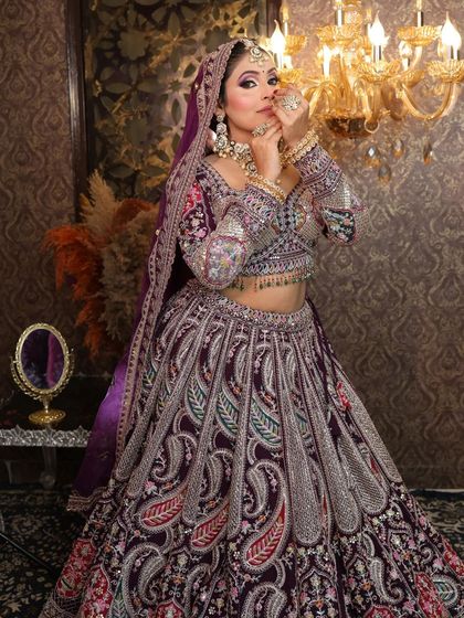 A playful pose in the purple paisley lehenga, showing the bride's personality.