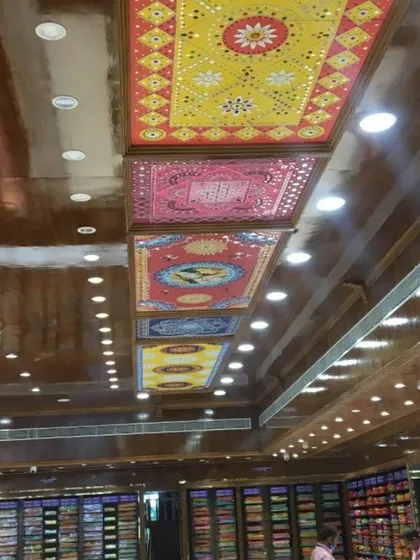 This is a large-scale commercial project we completed for a saree showroom in Bangalore. We designed and created a series of colorful Lippan art panels that run the length of the ceiling, creating a luxurious and memorable shopping experience.