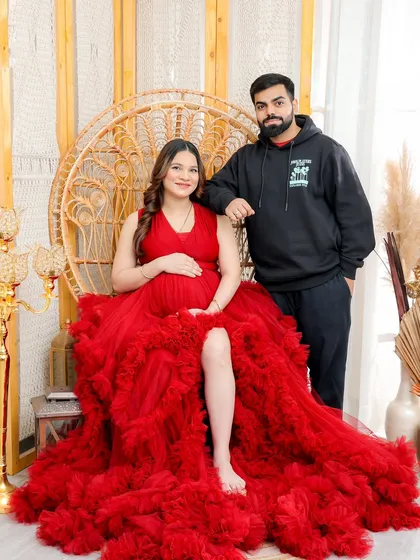 This shot shows how beautifully the red gown works for couple's portraits, creating a striking contrast with the partner's casual attire.