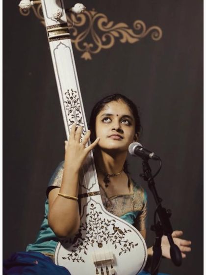 A portrait with my beautiful Miraj tanpura. This instrument is my constant companion on stage, providing the foundational 'shruti' or drone for my music.