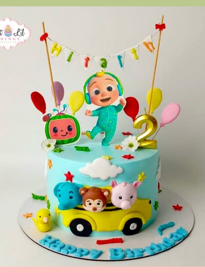 A sweet and colorful Cocomelon cake for a 2nd birthday. This design features JJ, a watermelon, and animal friends on the iconic yellow school bus.