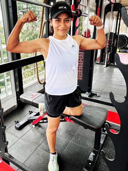 After a long run, it's the strength built in the gym that carries you through. Posing here after a tough session, feeling strong and ready for the miles ahead.