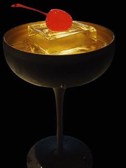 Glamour in a glass. This Cherry Martini, served in a chic matte black coupe with a clear ice cube, is the definition of elegance.
