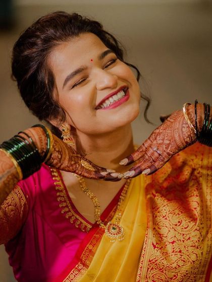A bride's glow is truly unmatched. This happy, candid shot shows how the right makeup can boost confidence and bring out the brightest smiles.