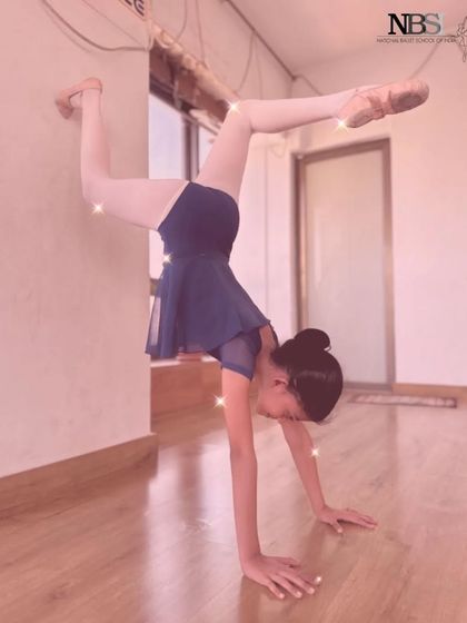 A young ballerina practicing a handstand against the wall. We incorporate elements of gymnastics to build strength and body awareness.