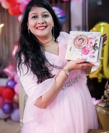 A proud mama holding the personalized first-year album for her daughter. Capturing these moments of joy is what my work is all about.
