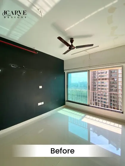 The "Before" shot of a bedroom project. The room started as a blank canvas with a dark accent wall and basic flooring.