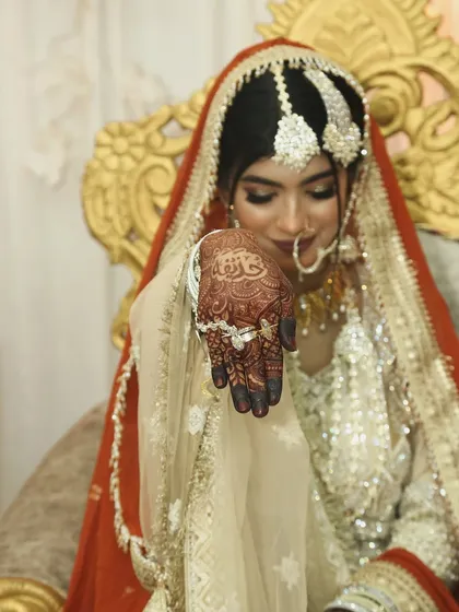 This bride's henna is the star of the show in this shot. Her Nikkah look is completed with a beautiful orange dupatta.