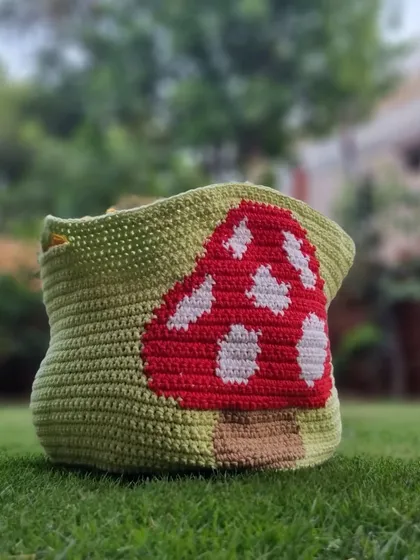 Crochet isn't just for clothes. I made this adorable mushroom-themed basket to hold my yarn and ongoing projects. It’s a fun, functional piece of home decor that adds a touch of handmade charm to my space, crafted with sturdy yarn to hold its shape.