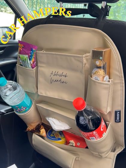A custom car organizer filled with snacks, drinks, and tissues. It's a thoughtful way to make the journey from the airport comfortable for the bride, groom, or special guests.