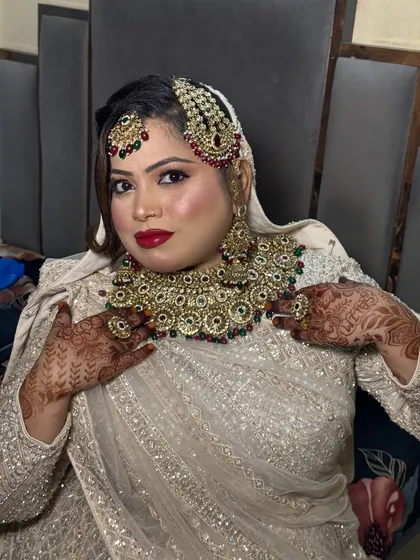 A beautiful portrait of my semi-bride. Her happiness with the final look, featuring glittery eyes and bold red lips, is evident.