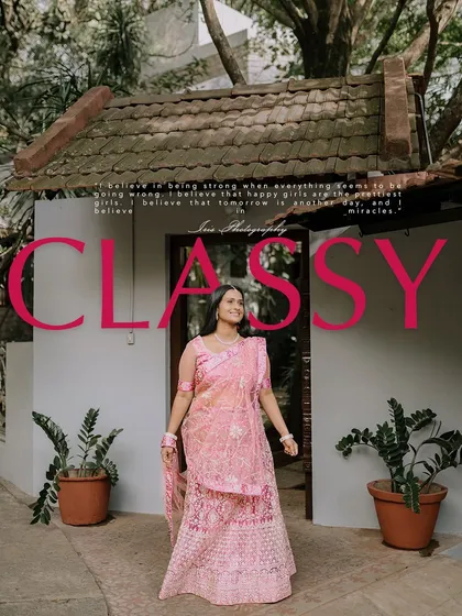 A full-length shot from the same "classy" series, showcasing the intricate pink lehenga against the backdrop of a traditional home.