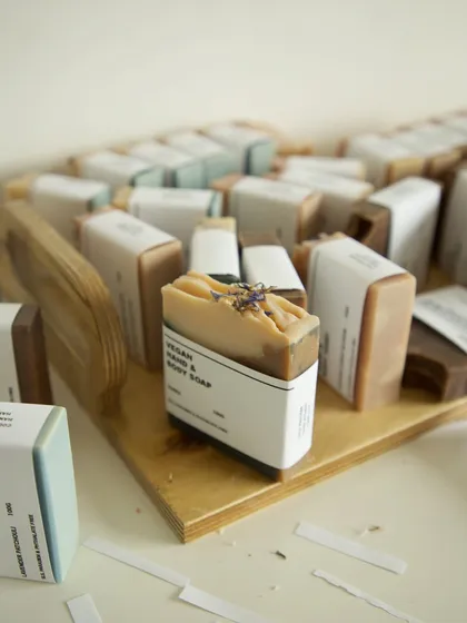 Using a wooden tray to organize soaps before they get their final paper wrap.