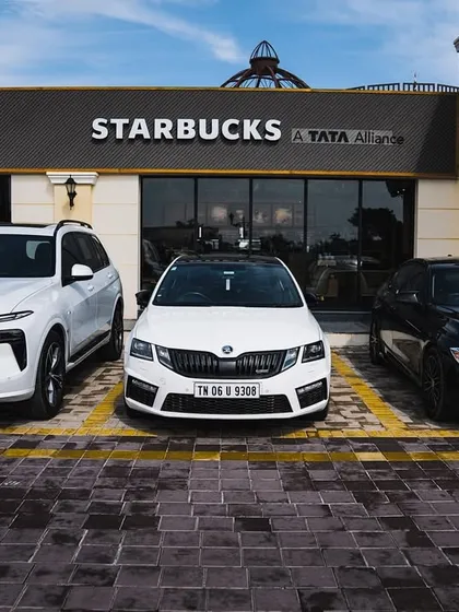 A powerful lineup of German and Czech engineering, featuring a BMW X7, a Skoda Octavia vRS, and another BMW parked in front of Starbucks.