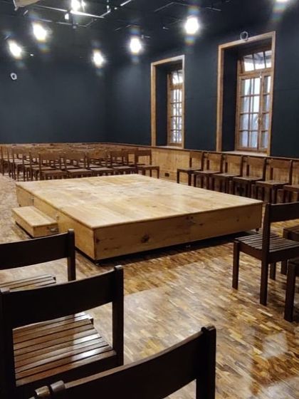 The completed Black Box Theatre, transformed from a design lab into a flexible performance space with a modular stage, professional lighting, and acoustic treatment.