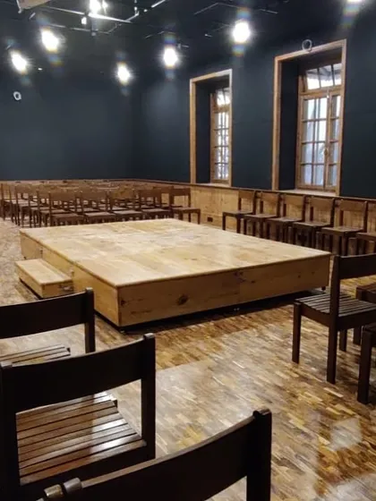 The completed Black Box Theatre, transformed from a design lab into a flexible performance space with a modular stage, professional lighting, and acoustic treatment.