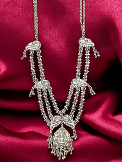 A premium pure silver necklace with beautiful, traditional details. This multi-strand piece features a central pendant with a deity motif, perfect for adding a touch of heritage to your look.