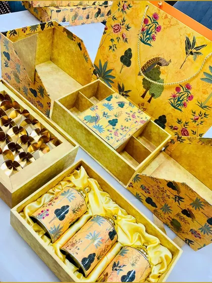 A complete view of our yellow peacock print wedding set, including the hamper box, sweet box, and matching gift bag. This coordinated set ensures a cohesive and luxurious gifting experience.