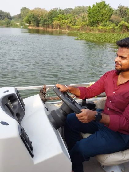 Enjoying the experience of steering a boat on the calm water.