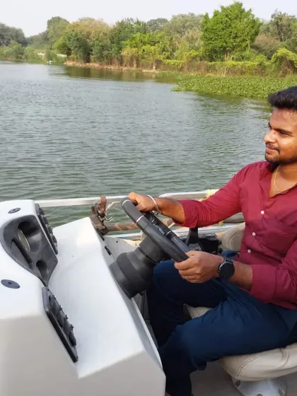 Enjoying the experience of steering a boat on the calm water.